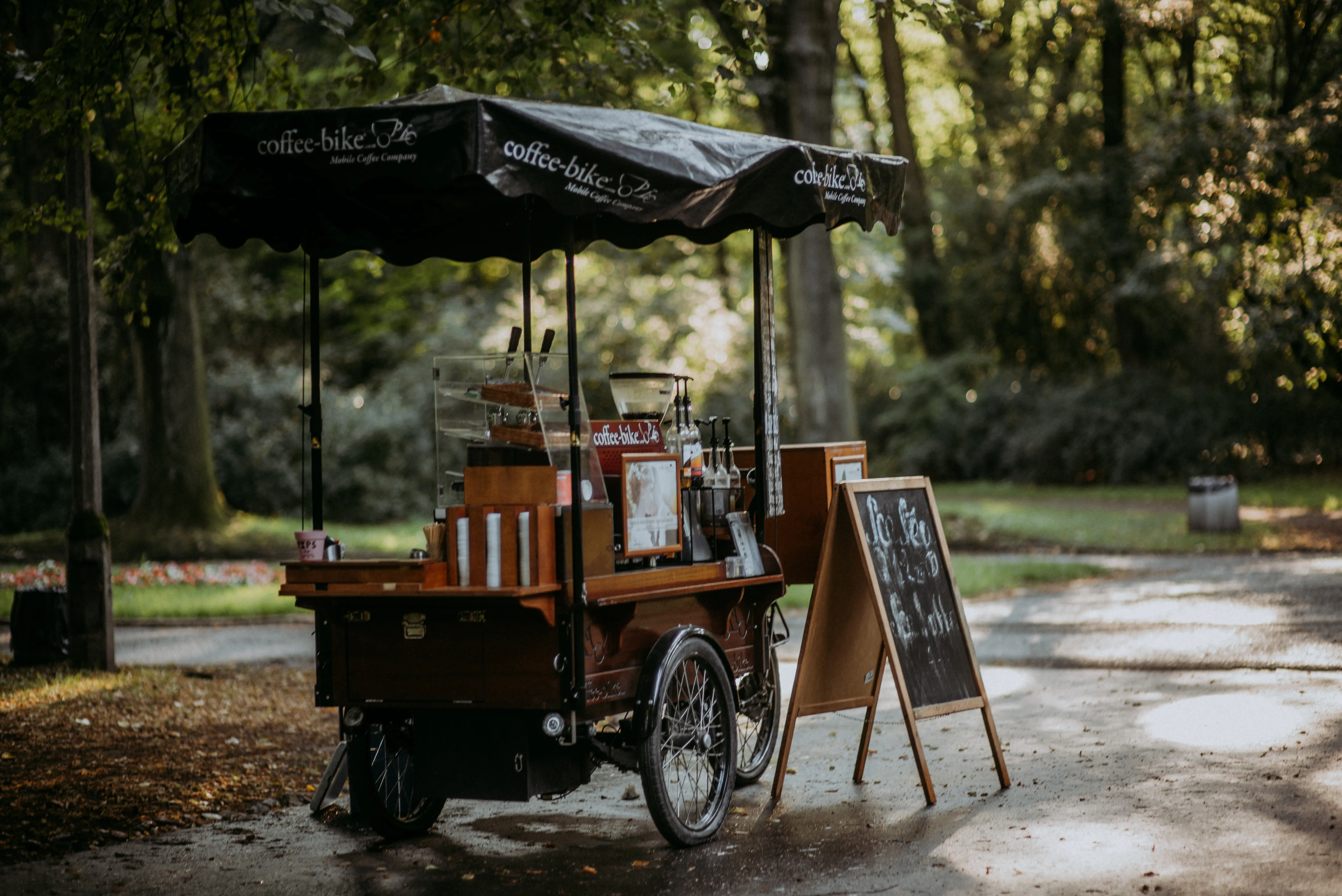A mobile coffee bike in a green park