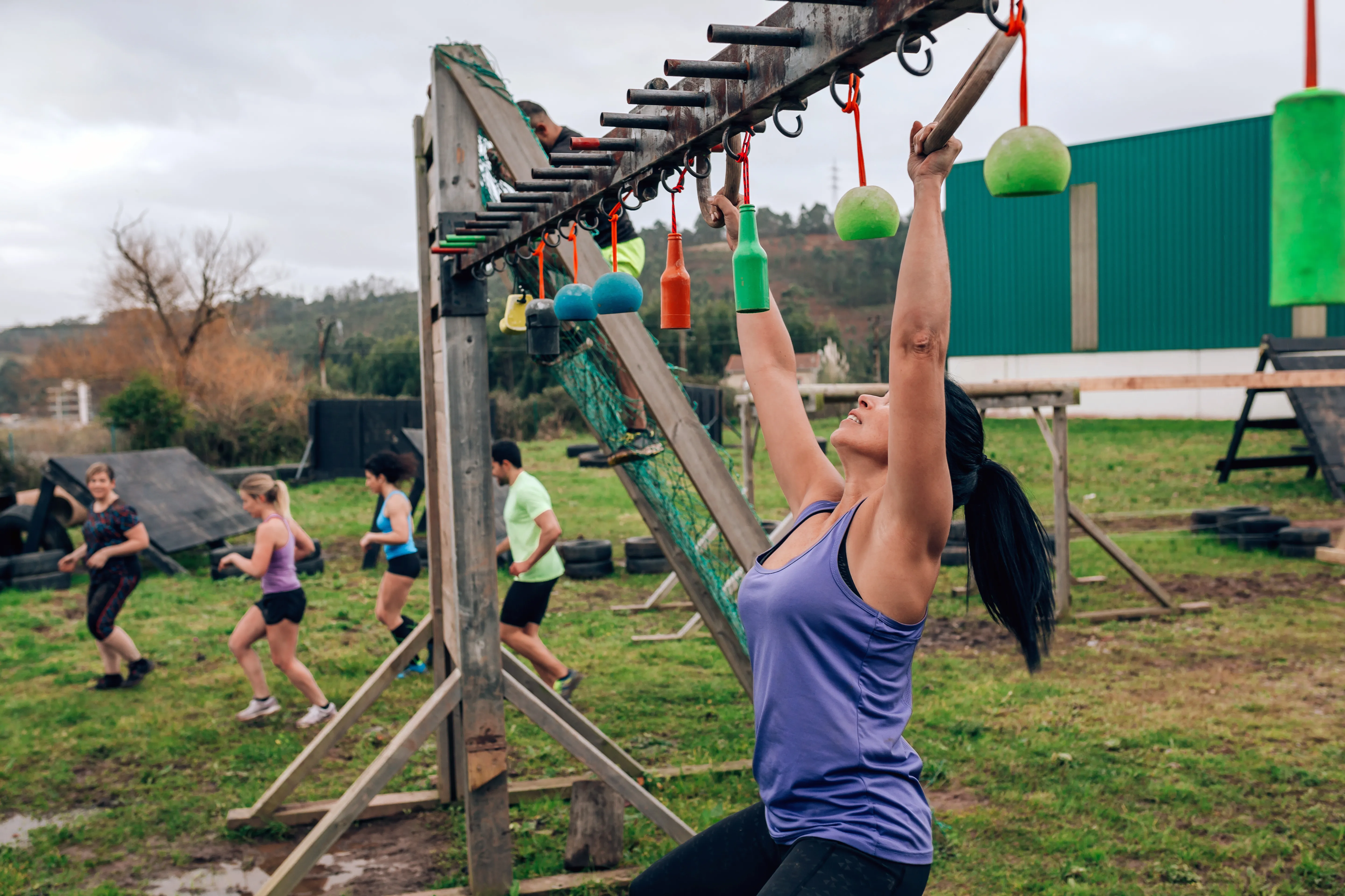 A runner climbing an outdoor obstacle
